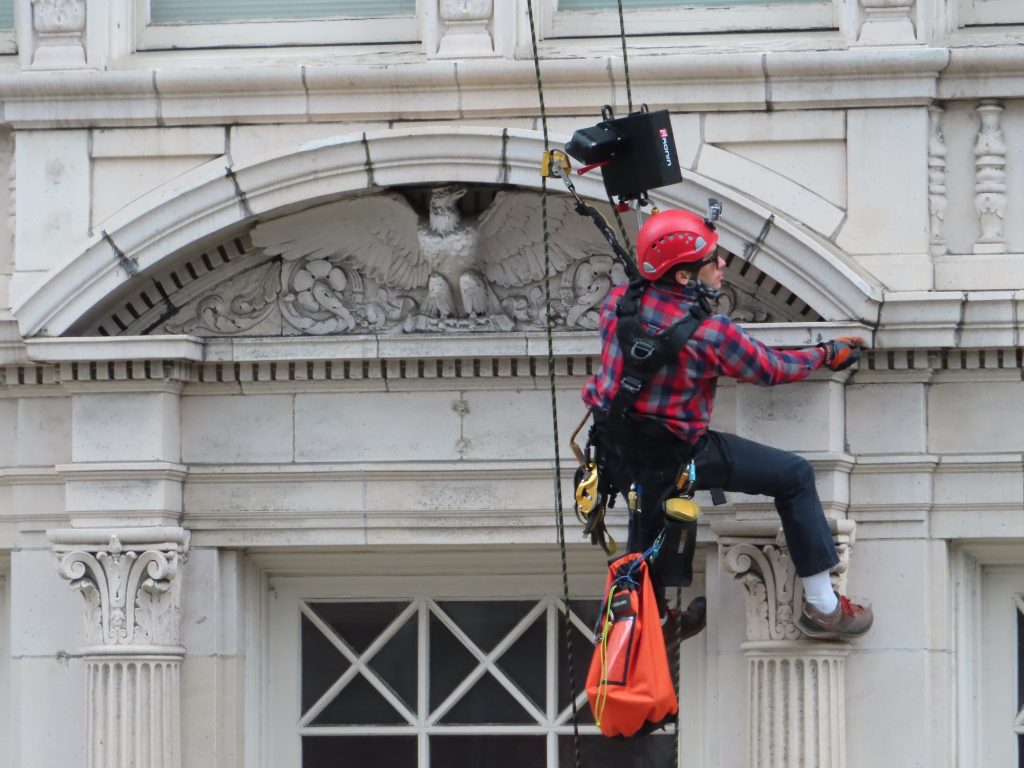 Rope access survey of a building with ornate terra cotta facade